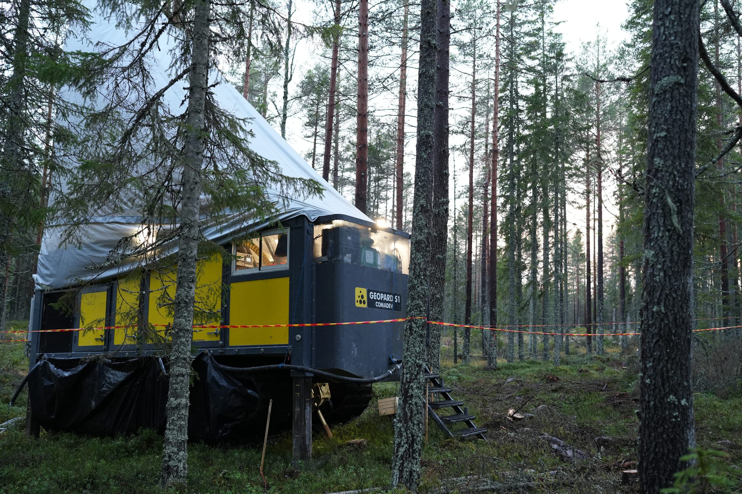 Diamond drill rig set up in the green pine forest