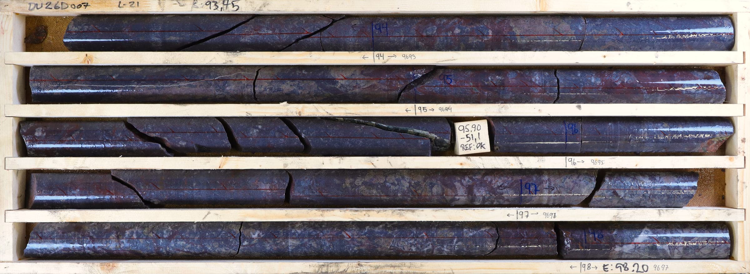 Wet drill core from hole DU26D007, 93.45–98.20 m, in a core box
